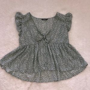 Green and white patterned blouse